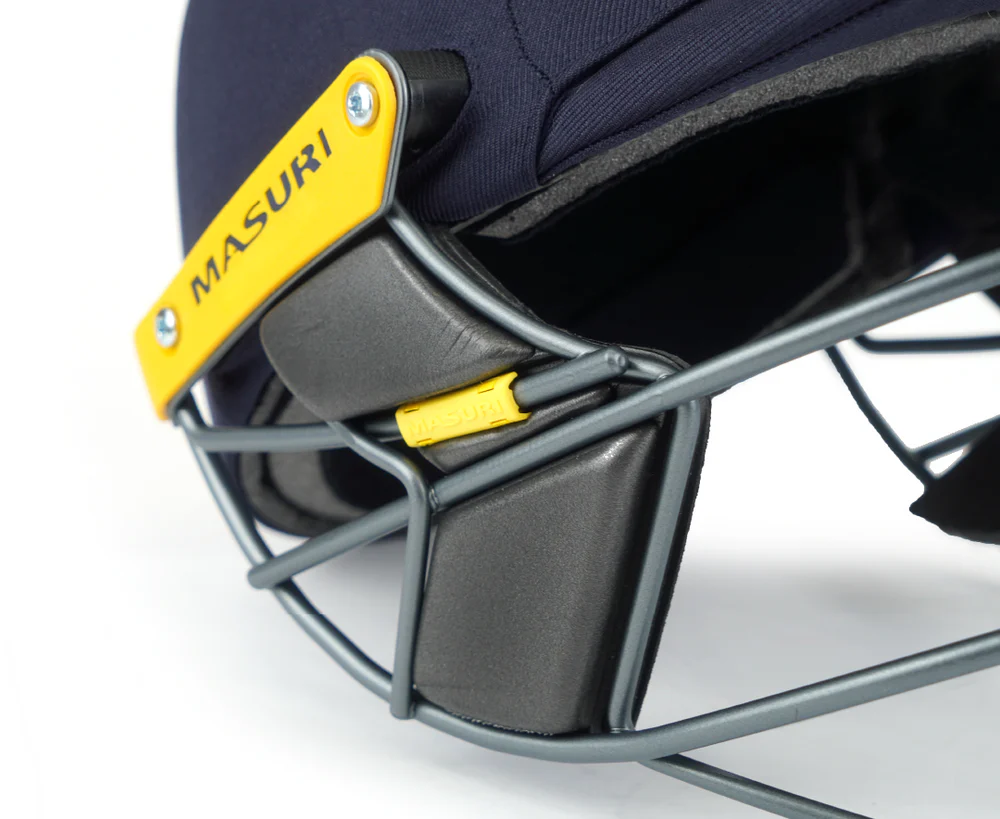 Close-up detail of the Masuri T-Line Steel cricket helmet, highlighting the grille attachment and branding.