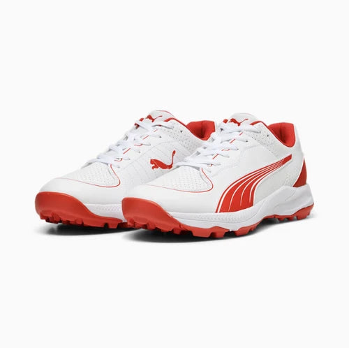 Pair of white Puma 24 FH Rubber Cricket Shoes with red Formstrip accents, red outsole, and white laces.