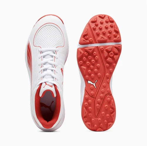 Top view of the Puma 24 FH Rubber Cricket Shoe next to its red rubber studded sole with multi-directional tread pattern.