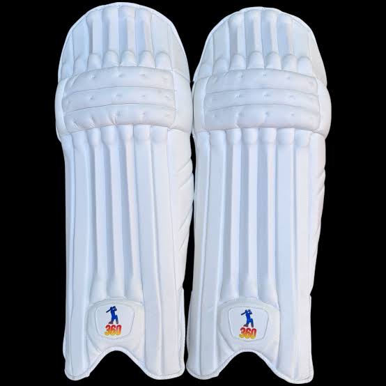 Front face and inner padded back view of EM 360 PLAY BURST adult black cricket batting pads on artificial grass on Alberta.