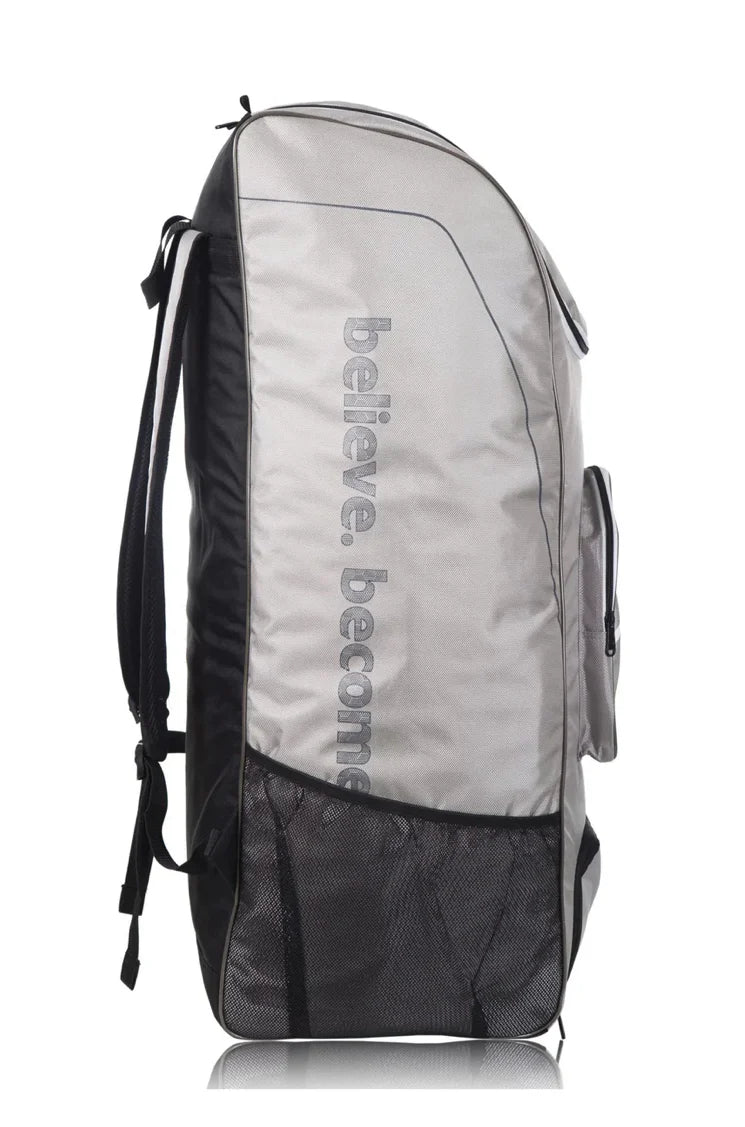Side profile view of a grey SG Ashes cricket duffle backpack from Albertacricketstore.com, featuring "believe. become" text printed vertically and a lower mesh pocket.