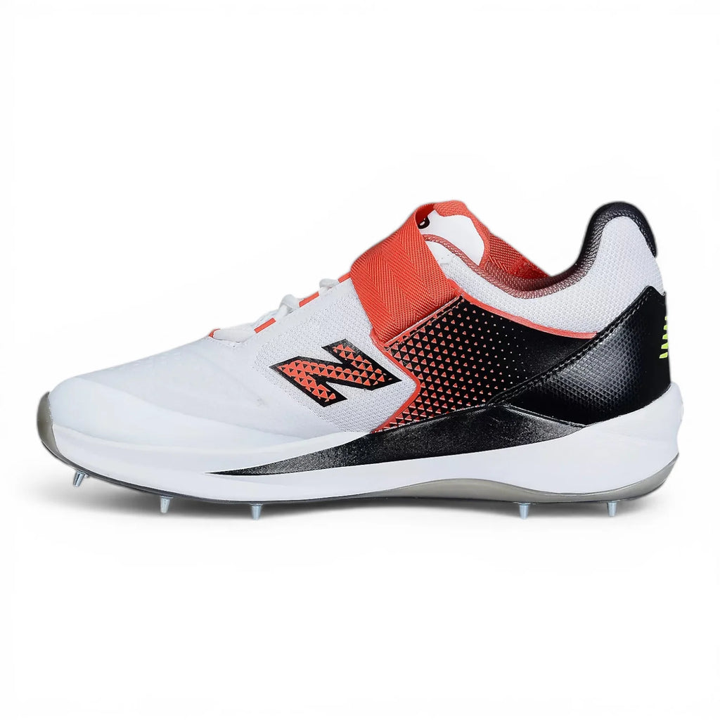 Side profile view of New Balance CK4040 F7 spike cricket shoe in white with red midfoot strap, black heel counter, and metal spikes on outsole