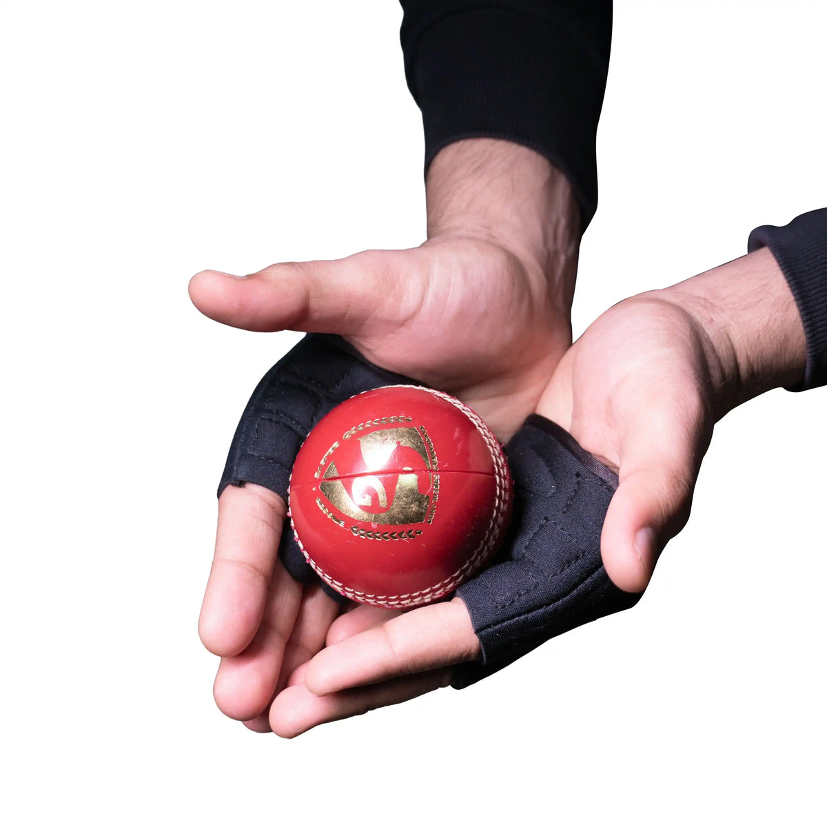 Close-up of hands wearing SG HP 33 black catching practice gloves holding a red leather cricket ball.