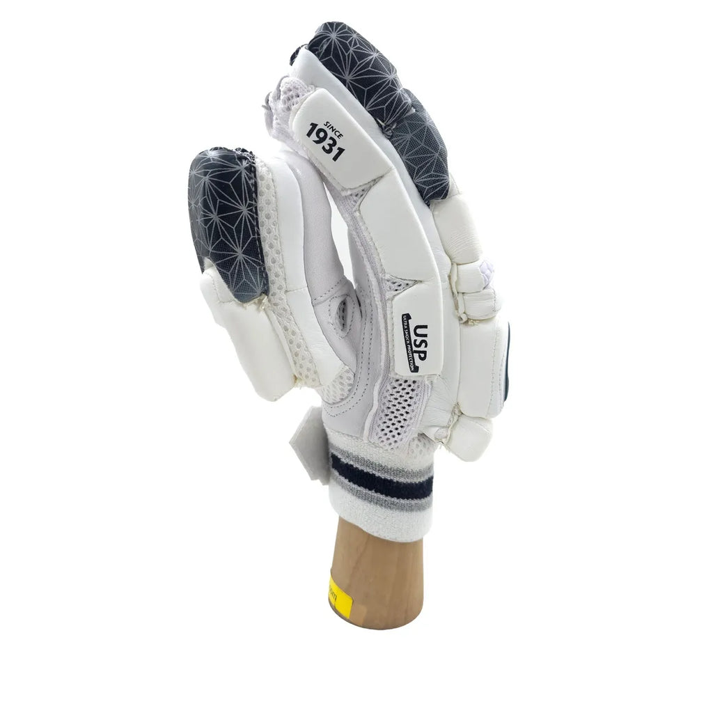 Side profile view of SG Hilite 2.0 adult cricket batting glove showing white side finger padding and thumb protection on a wooden display stand.