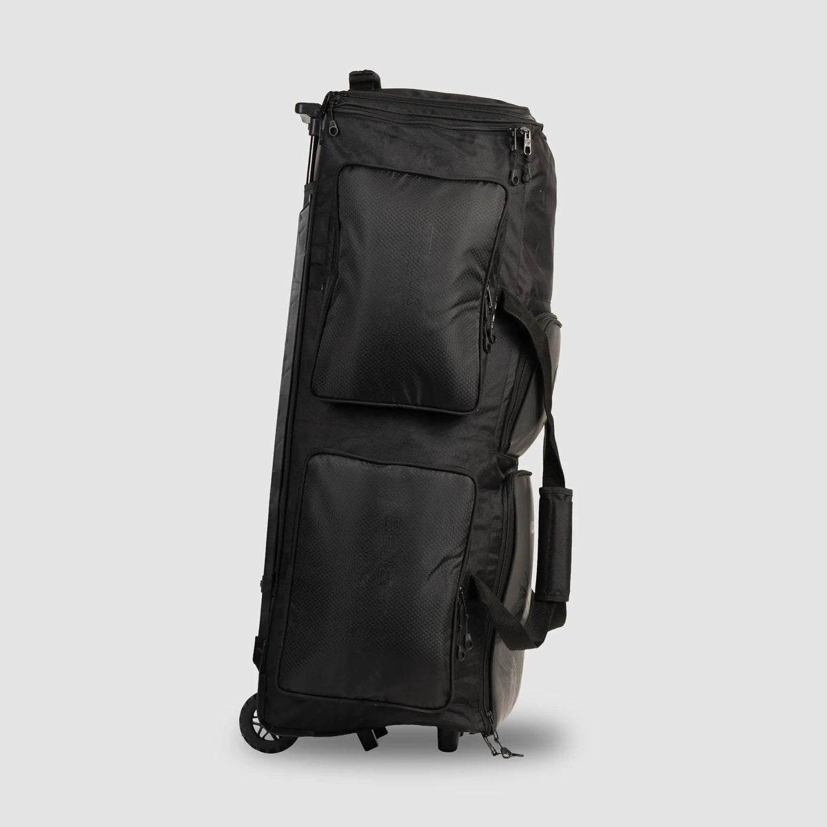 Three-quarter angle view of black SG KLR Wheelie Trunk cricket kit bag showing dual front zipped pockets and side carry straps.