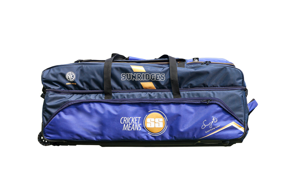 Back view of Gray-Nicolls GN9 International duffle wheelie cricket bag showing red and black padded shoulder straps and wheels on Alberta.
