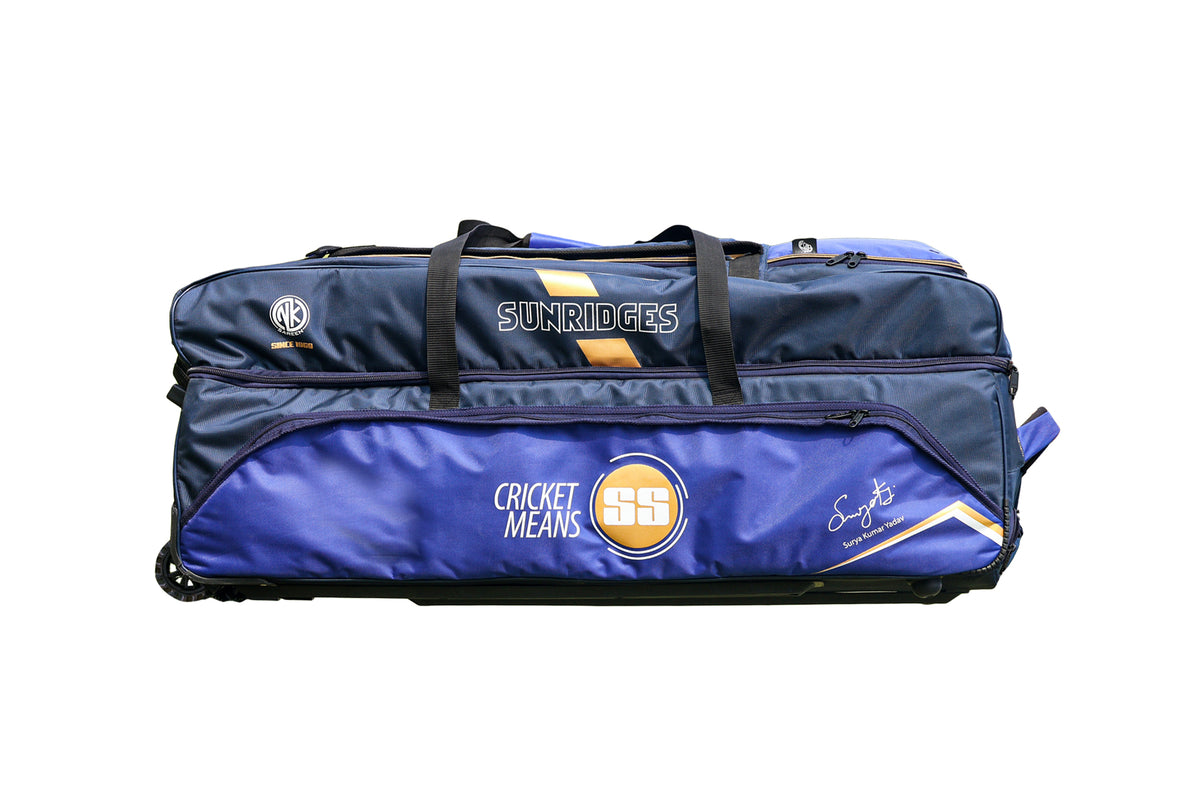 Back view of Gray-Nicolls GN9 International duffle wheelie cricket bag showing red and black padded shoulder straps and wheels on Alberta.