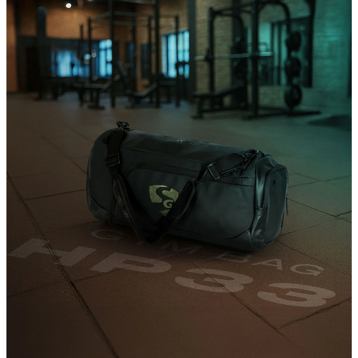 Side view of the black SG HP33 gym bag showing the mesh pocket structure and heavy-duty adjustable shoulder strap attachment.