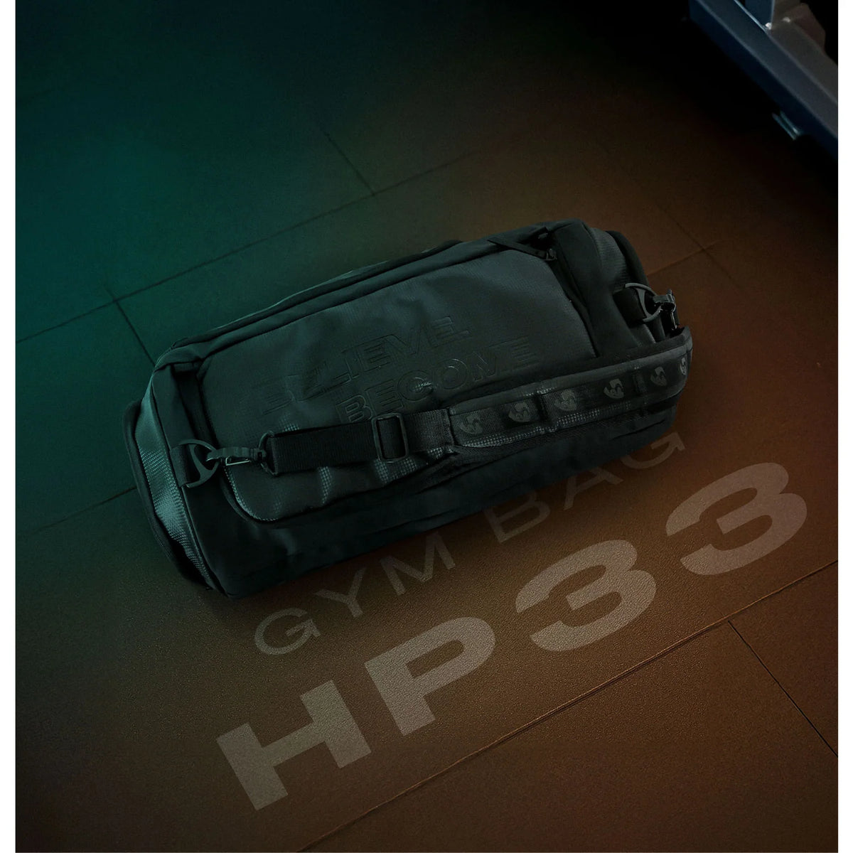 Top angle lifestyle shot of the black SG HP33 gym bag resting on a textured floor with GYM BAG HP33 text.