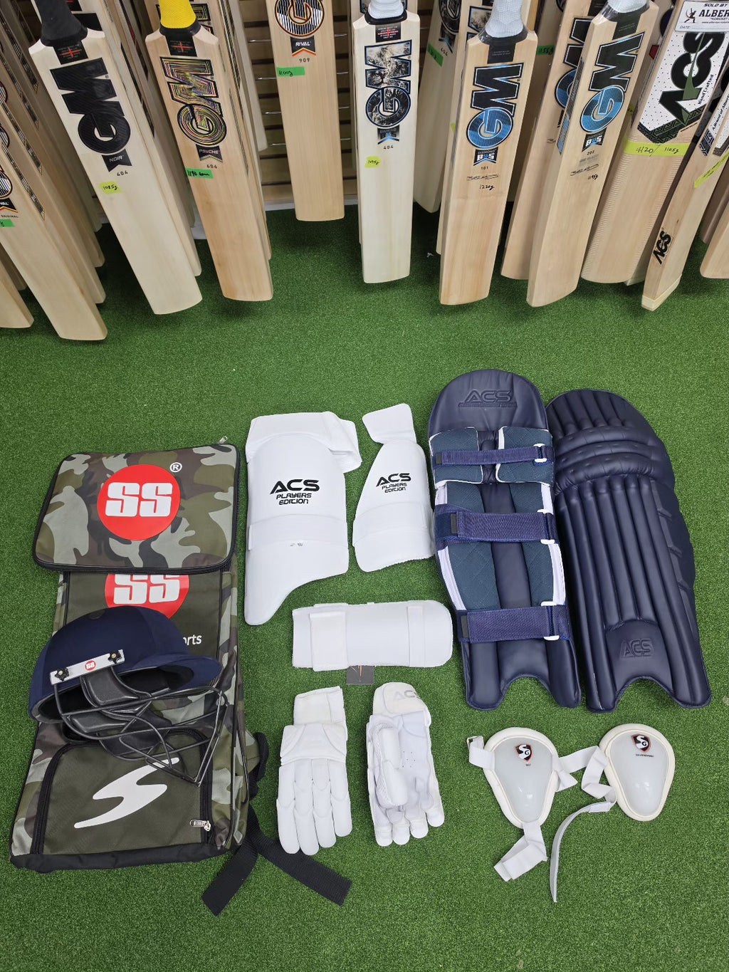Premium cricket bats display with complete protective gear set and kit bag