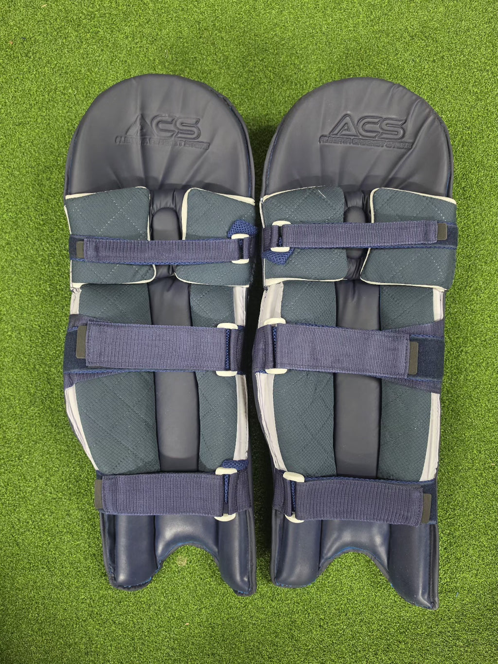 ACS Player Edition navy blue batting pads – rear view with straps