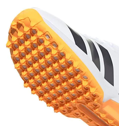 Close-up angled view of the front orange rubber traction studs and lugs on the Adidas 22YDS Spikeless Cricket Shoe.