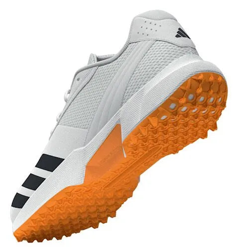 Rear underside view of a white Adidas 22YDS cricket shoe showing the heel and orange outsole.