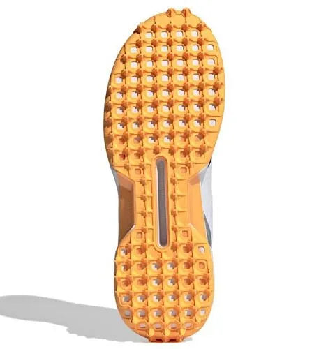 Direct flat bottom view of the orange rubber outsole of the Adidas 22YDS Spikeless Cricket Shoe showing the traction lug pattern.
