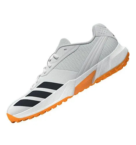 Front-angled view of white Adidas 22YDS Spikeless Cricket Shoes featuring black stripes and an orange sole