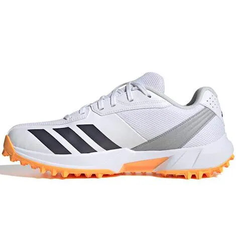Dynamic floating side profile view of the white Adidas 22YDS Spikeless Cricket Shoe featuring black stripes and a bright orange sole