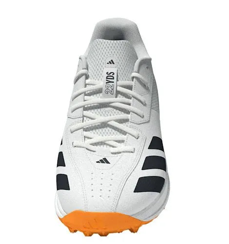 Straight front-on view of the white Adidas 22YDS Spikeless Cricket Shoes with signature black stripes, white laces, and an orange toe bumper.