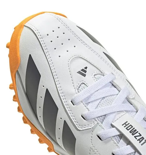 Close-up of the white Adidas Howzat shoe toe, laces and grey side stripes with an orange outsole.