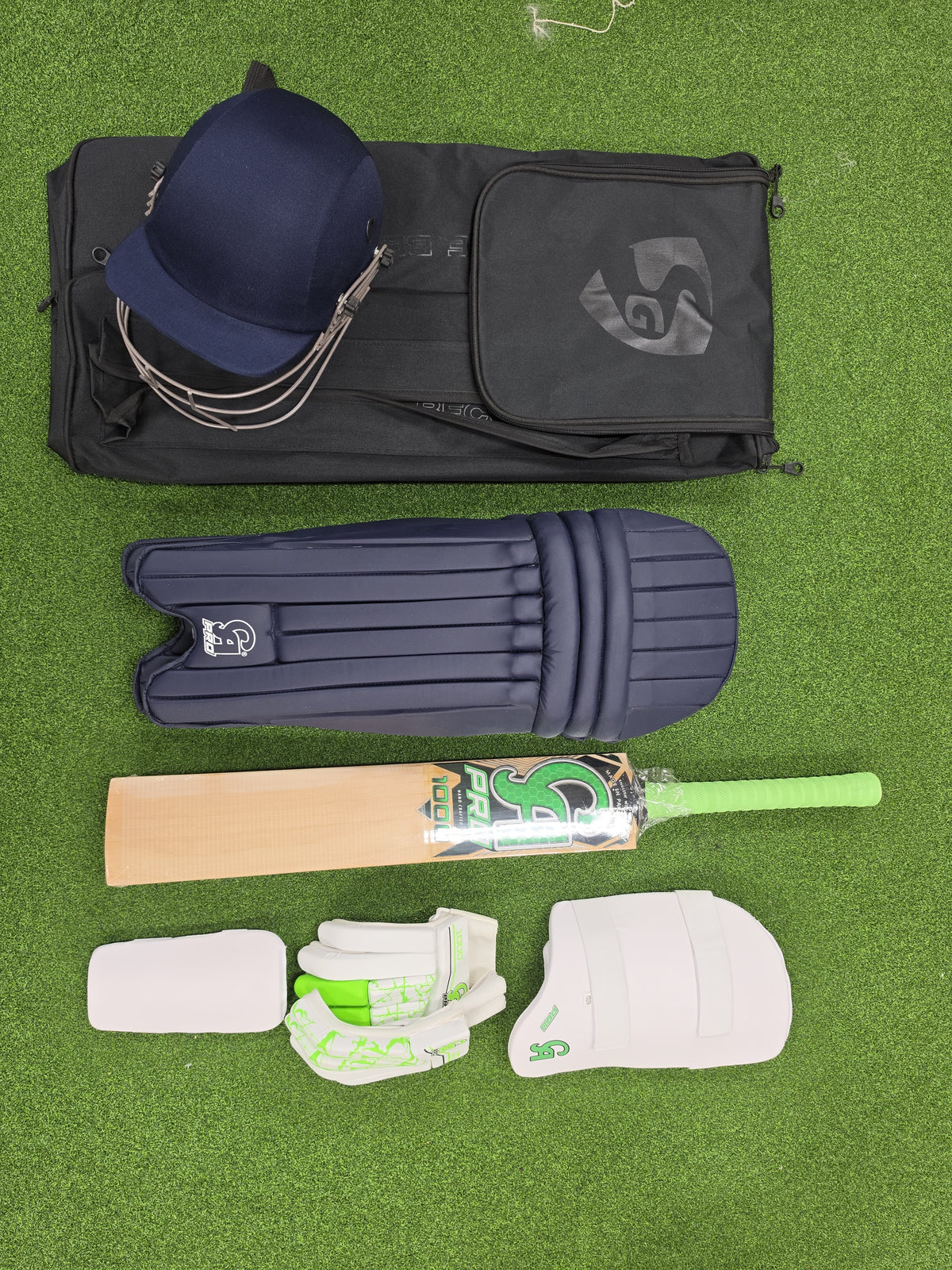 CA PRO 1000 Junior Youth Complete Cricket Kit Size 6 with helmet, English willow bat, pads, and gloves on grass by Alberta Cricket Store.