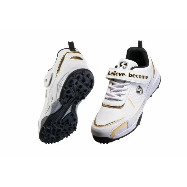 Pair of white SG Century 5.0 cricket shoes with gold accents, showing the rubber studded sole and the front view with "believe. become" midfoot strap