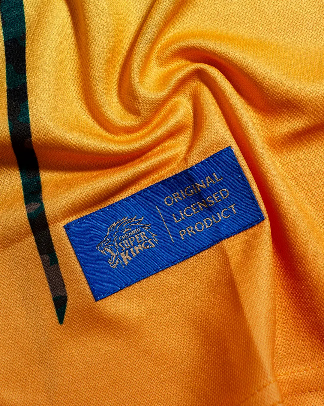 Close-up of the Chennai Super Kings label reading Original Licensed Product on a yellow jersey.