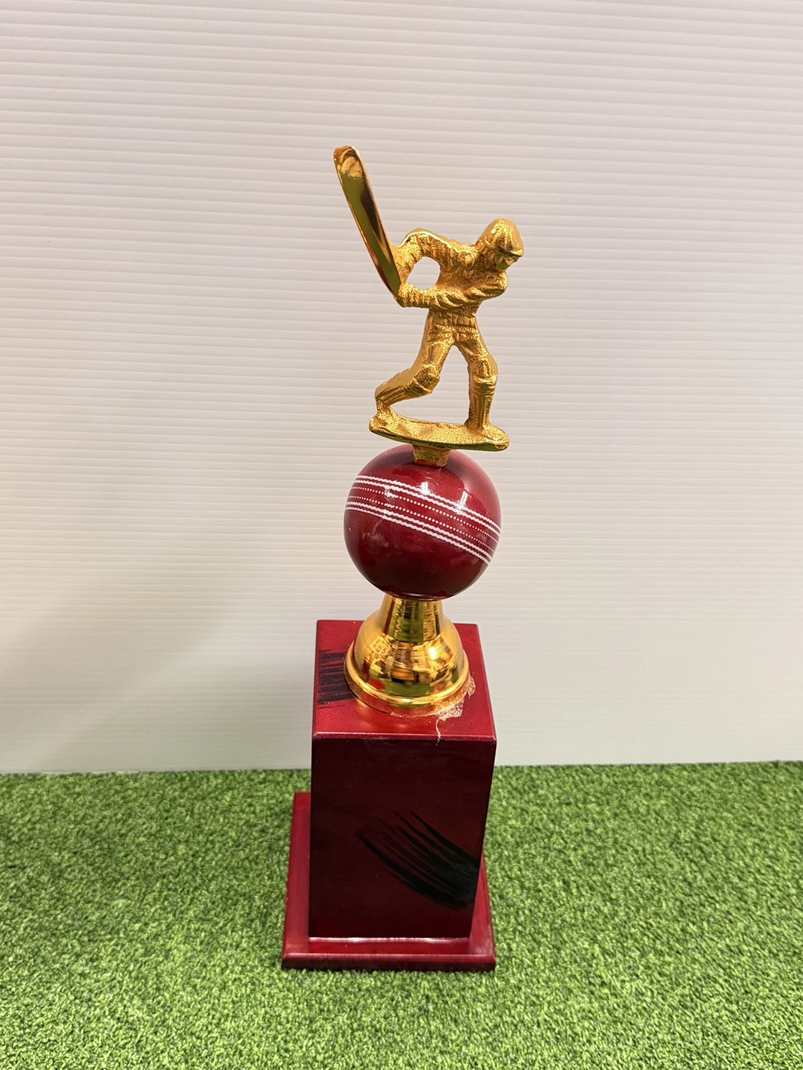16-inch cricket trophy featuring a golden batsman on a red seam cricket ball with a wooden base - Albert Cricket Store