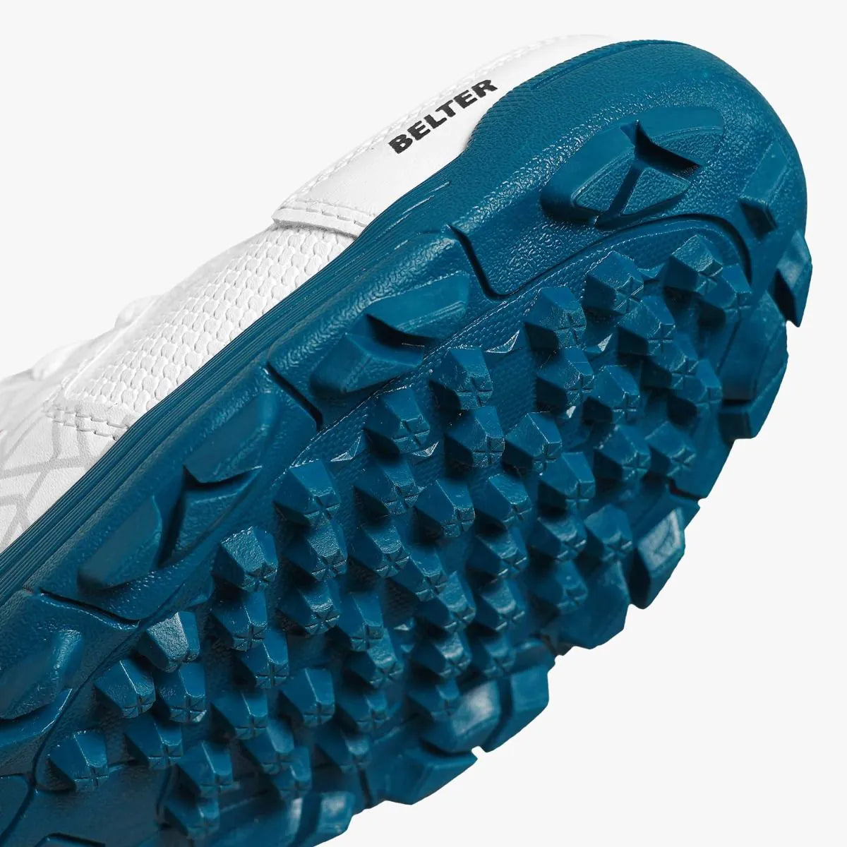 Close-up view of DSC Belter cricket shoe teal rubber studded outsole tread pattern.