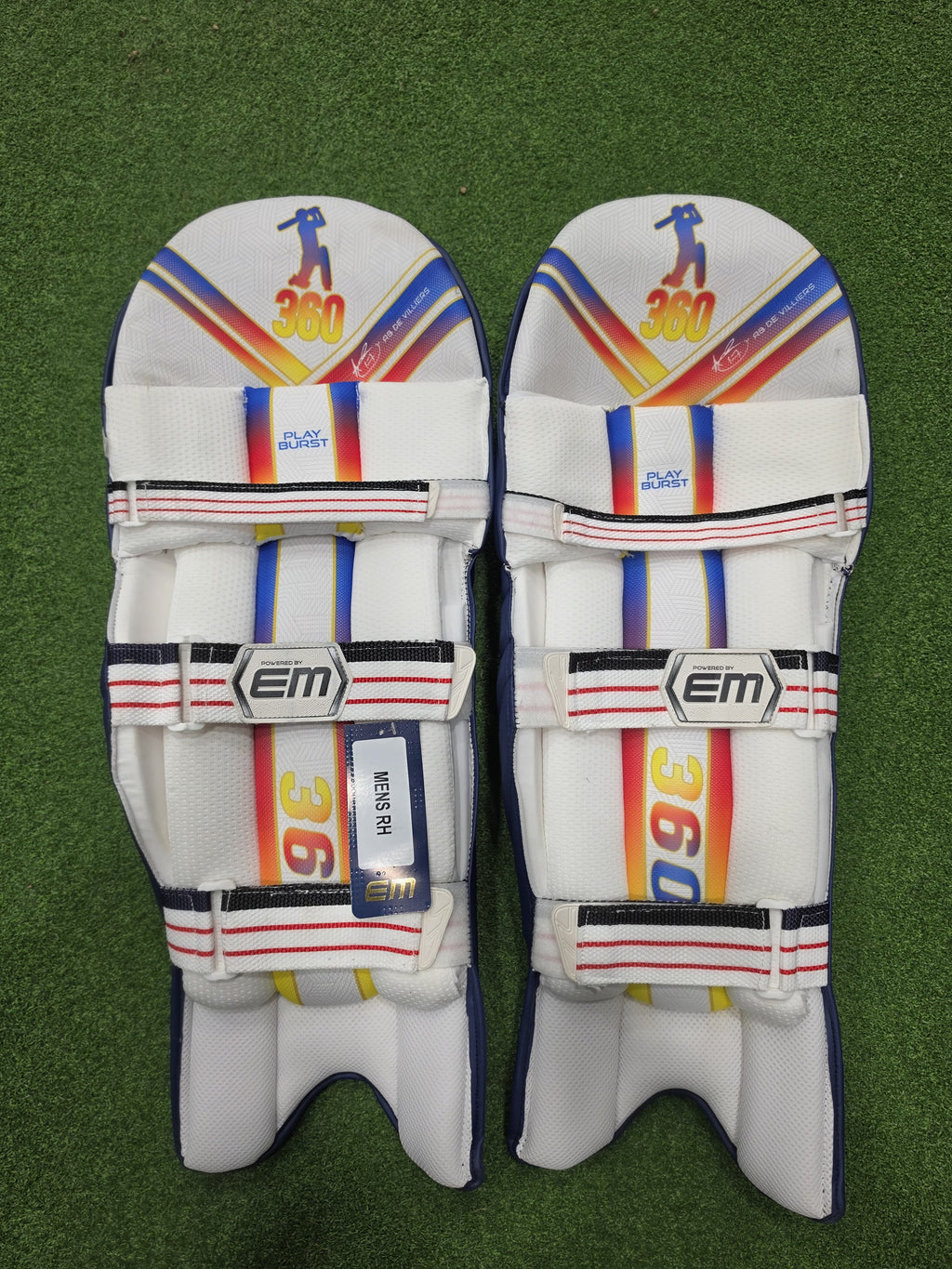 Inner back padded view of EM 360 PLAY BURST adult navy blue cricket batting pads on artificial turf on Alberta.