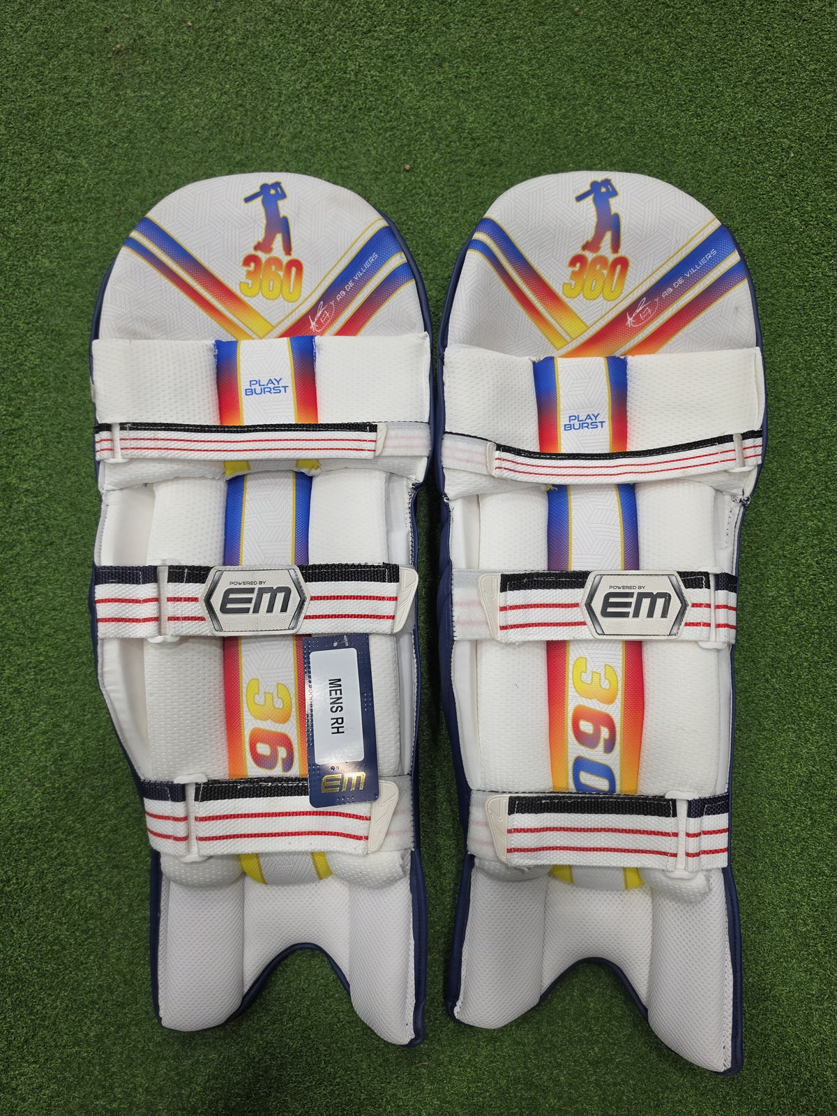 Inner back padded view of EM 360 PLAY BURST adult navy blue cricket batting pads on artificial turf on Alberta.