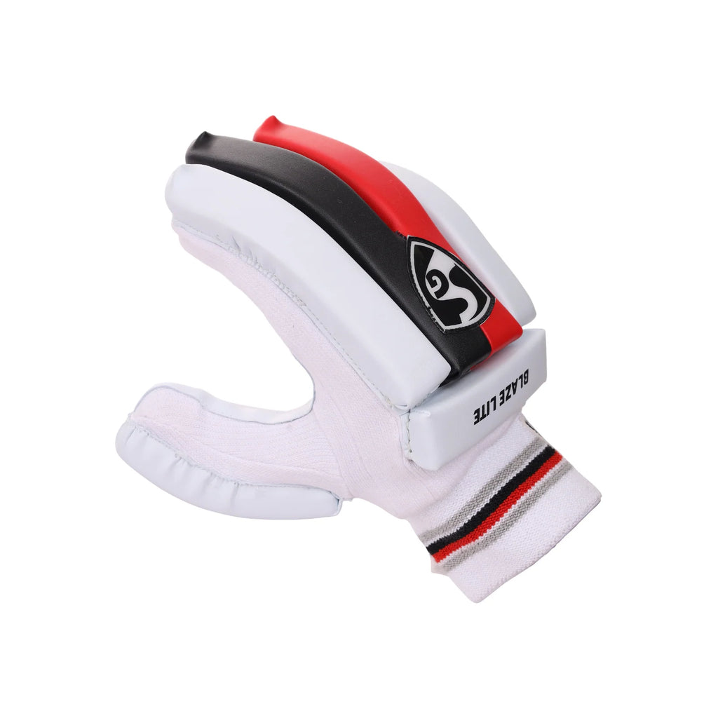 Angled backhand view of a white SG Blaze Lite junior batting glove with red and black finger panels.