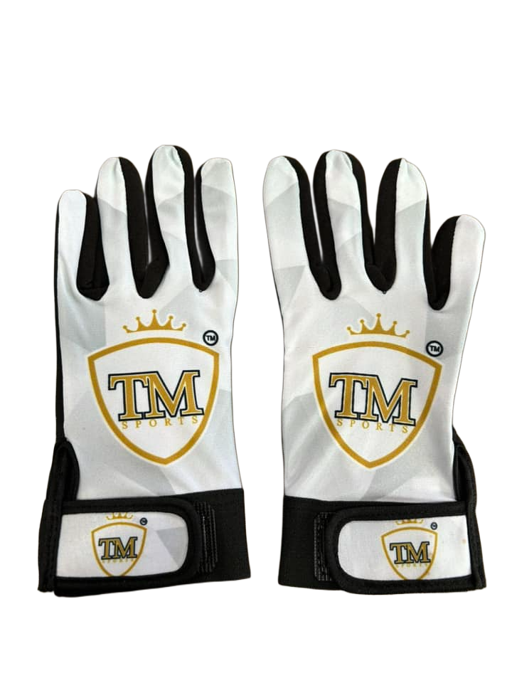 Backhand view of white TM tape ball batting gloves with gold logos and black wrist straps.