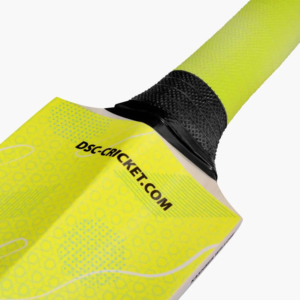 Close-up detail view of DSC Wildfire Warrior tennis cricket bat handle join and vibrant lime green rubber grip.
